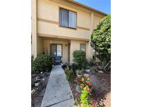 Charming townhome with a well maintained front yard and walkway leading to the entrance at 1448 Highland Ridge Cir, Brandon, FL 33510