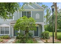 Charming townhouse featuring a well-manicured front yard and a freshly painted exterior in a tranquil community setting at 2314 Lake Woodberry Cir, Brandon, FL 33510