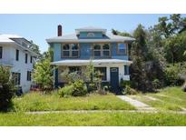 Inviting two-story home boasts classic architecture and a spacious front yard at 2355 Trelain S Dr, St Petersburg, FL 33712