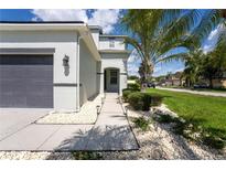 Inviting front yard featuring lush landscaping, decorative stones, and a well-maintained walkway at 9110 Lantern Oak Way, Land O Lakes, FL 34638