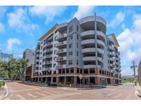 Modern condo building with balconies, brick accents and street view, perfect for urban living at 1108 N Franklin St # 602, Tampa, FL 33602