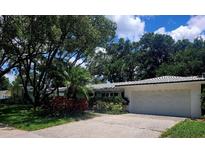 Charming single-story home with mature trees and a well-maintained front yard at 2328 Harn Blvd, Clearwater, FL 33764