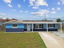 Charming single-story home featuring a covered entrance, updated paint, manicured lawn, and a spacious driveway at 3427 Cantrell St, Holiday, FL 34690