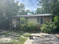 The home's front exterior features stone details and mature trees in the surrounding landscape at 3518 16Th S Ave, St Petersburg, FL 33711
