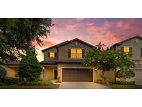 Inviting two-story home boasts lush landscaping and a two-car garage at 5239 Fallen Leaf Dr, Riverview, FL 33578