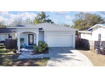 Charming single-story home featuring a well-manicured lawn and a two-car garage with a brick-paved driveway at 5528 40Th N St, St Petersburg, FL 33714