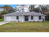 Charming single-story home with a well-manicured lawn and a classic architectural design at 5580 S Salford Blvd, North Port, FL 34287