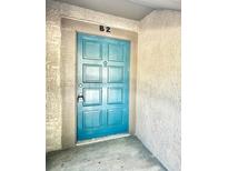 Condo front door painted in a bright turquoise color and numbered with 'B2' above it at 6344 Newtown Cir # B2, Tampa, FL 33615