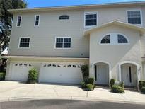 Well-maintained two-story home featuring a multi-car garage and inviting front entrances at 8158 Eagles Park N Dr, St Petersburg, FL 33709
