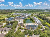 Expansive aerial view of condo community with lakes, landscaping, and golf course at 960 Starkey Rd # 10505, Largo, FL 33771
