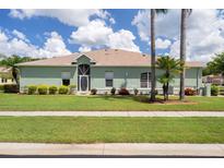 Charming single-story home with lush green lawn and well-maintained landscaping at 11439 Golf Round Dr, New Port Richey, FL 34654