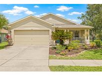 Charming single-Gathering home with well-manicured lawn and an attached two-car garage at 11830 Autumn Creek Dr, Riverview, FL 33569