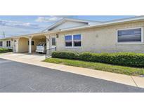 Charming one-story villa featuring a covered carport, well-maintained landscaping, and a welcoming entrance at 12400 Park Blvd # 519, Seminole, FL 33772