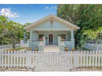 Charming bungalow with a welcoming front porch and white picket fence at 1415 7Th N Ave, St Petersburg, FL 33705