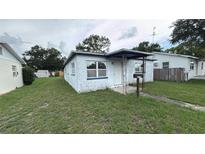 View of a single story home featuring a covered porch and small front yard at 2410 38Th N Ave, St Petersburg, FL 33713