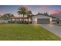 Charming single-story home featuring a manicured lawn and a spacious two-car garage at 3197 Walnut Ne St, St Petersburg, FL 33704