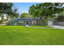 Charming one story home with mature trees and a lush green lawn at 3620 Little Rd, Lutz, FL 33548