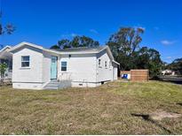 Charming single-story home with a white stucco exterior and a bright blue front door at 4701 17Th S Ave, St Petersburg, FL 33711