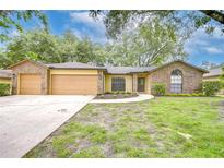 Charming single-story home with brick accents, well-maintained landscaping, and attached two-car garage at 512 Pinewalk Dr, Brandon, FL 33510