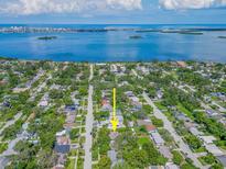 Stunning aerial view of a coastal community with easy access to the bay, showcasing the neighborhood and water views at 1136 Granada St, Clearwater, FL 33755