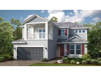 Charming two-story home with a balcony, gray siding, a gray shingle roof, and a well-kept landscaped yard at 1678 Trailhead Ln, Zephyrhills, FL 33541