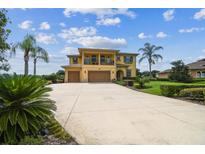 Stunning two-story home featuring an oversized driveway and manicured landscaping at 17914 Howsmoor Pl, Lutz, FL 33559