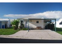 Charming single-story home featuring a covered parking area and well-maintained landscaping at 195 N Saint Thomas Cir, Apollo Beach, FL 33572