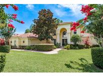 Inviting home showcasing a well-manicured lawn and lush landscaping at 3042 Wentworth Way, Tarpon Springs, FL 34688