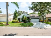 Charming single-story home with manicured lawn and lush landscaping at 4167 Seton Cir, Palm Harbor, FL 34683