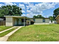 Modest single-story home featuring a covered carport and a well-maintained front lawn at 5016 S 86Th St, Tampa, FL 33619