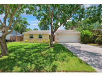 Charming one-story home with a well-maintained lawn and inviting curb appeal at 602 Timber Bay W Cir, Oldsmar, FL 34677