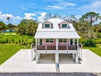 Charming raised home with a metal roof and a spacious ground-level parking and entertaining area at 6715 Wander Ln, New Port Richey, FL 34654