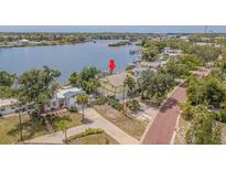 Waterfront home featuring a private dock, scenic views, and lush landscaping in a desirable neighborhood at 739 Chesapeake Dr, Tarpon Springs, FL 34689
