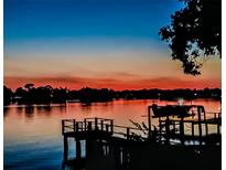 Beautiful waterfront view from a pier, displaying the captivating sunset and calming silhouette in the horizon at 739 Chesapeake Dr, Tarpon Springs, FL 34689