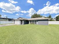 Charming single-story home featuring a well-maintained lawn and a two-car garage at 800 Embassy Rd, Largo, FL 33771