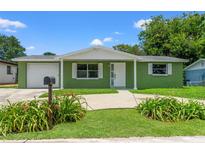 Charming single-story home featuring a freshly painted exterior and meticulously maintained landscaping at 10039 Old Hickory Ln, Port Richey, FL 34668