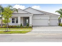 Charming single Gathering home with manicured landscaping and a three-car garage at 11622 Gleaming Ter, Venice, FL 34293