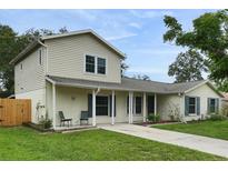 Charming two-story home boasts a well-maintained lawn, inviting entryway, and appealing architectural details at 1305 Willow Valley Dr, Brandon, FL 33510