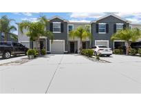 Charming townhomes with well-maintained lawns, palm trees, and ample parking spaces for residents and visitors at 2699 Suncoast Blend Dr, Odessa, FL 33556