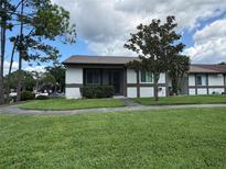 Charming single-story home with well-maintained lawn, mature tree, and welcoming front entrance at 2900 Grovewood Blvd # A, Palm Harbor, FL 34683