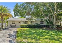 Charming single-story home with a well-maintained lawn and mature landscaping provides great curb appeal at 4530 Catalonia S Way, St Petersburg, FL 33712
