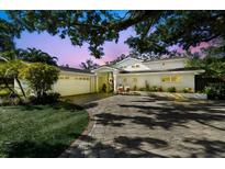 Stunning home with manicured lawn, paver driveway, attached garage, and inviting covered front entrance at 4722 W Laurel Rd, Tampa, FL 33629