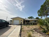 Charming single-story home with a well-maintained front yard, driveway, and attached one-car garage at 2113 Greenbriar Blvd, Clearwater, FL 33763