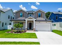 Charming two-story home featuring stone accents, a well-manicured lawn, and a two-car garage at 1015 W Charter St, Tampa, FL 33602
