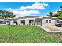 Charming single-story home with a well-manicured lawn and tasteful landscaping at 1029 Madison St, Largo, FL 33770