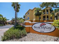 Sunny view of Beachway Condominiums community sign, surrounded by lush tropical landscaping at 10764 70Th Ave # 4305, Seminole, FL 33772