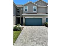 Charming townhome featuring a two-car garage and a beautifully paved driveway at 11634 Woodleaf Dr, Bradenton, FL 34211