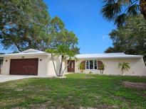 Charming single-story home with a lovely front lawn and mature trees providing ample shade at 13344 88Th Ave, Seminole, FL 33776