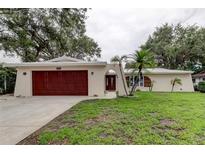 Charming single-story home features a two-car garage, well-kept lawn, and stylish front door at 13344 88Th Ave, Seminole, FL 33776
