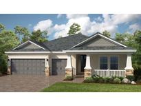 Charming single-story home with a two-car garage and beautifully landscaped front yard at 35154 Emberview Dr, Zephyrhills, FL 33541